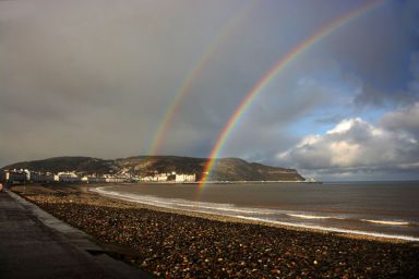 A rainbow above the beach and sea