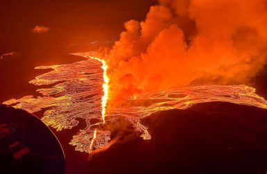 This handout picture released by the Icelandic Coast Guard on March 16, 2024 shows billowing smoke and flowing lava pouring out of a new fissure during a new volcanic eruption on the outskirts of the evacuated town of Grindavik, western Iceland. A volcanic eruption started on the Reykjanes peninsula in southwestern Iceland on Thursday, the third to hit the area since December, authorities said. 