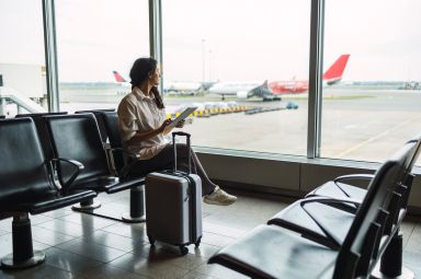 Woman looking out of window in airport