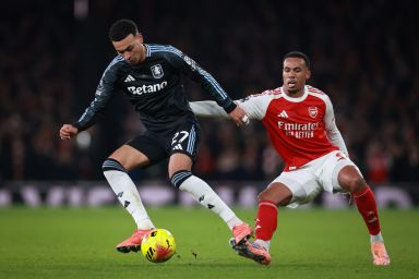 Morgan Rogers of Aston Villa under pressure from Gabriel Magalhaes of Arsenal during the Premier League match between Arsenal and Aston Villa at Emirates Stadium on December 30, 2025 in London, England. 