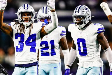 Three American football players in white and blue kits