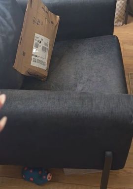 The parcel on the woman's armchair in her living room