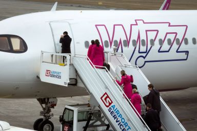 The flight crew boards a Wizz Air Malta Airbus A321neo, registration 9H-WAD, via mobile stairs as the aircraft is prepared for departure at Katowice Airport in Pyrzowice, 