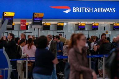 Passengers queue at check-in at the British Airways terminal, Terminal 5, at London Heathrow Airport