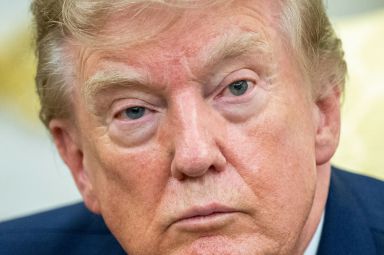 President Donald Trump looks on as as he meets with lifeguard Ryder Williams in the Oval Office of the White House in Washington, DC, on August 17, 2026. 